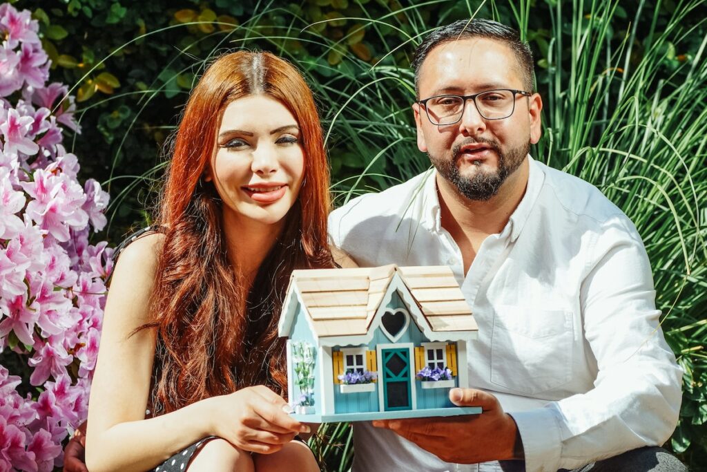 Couple-holding-miniature-house