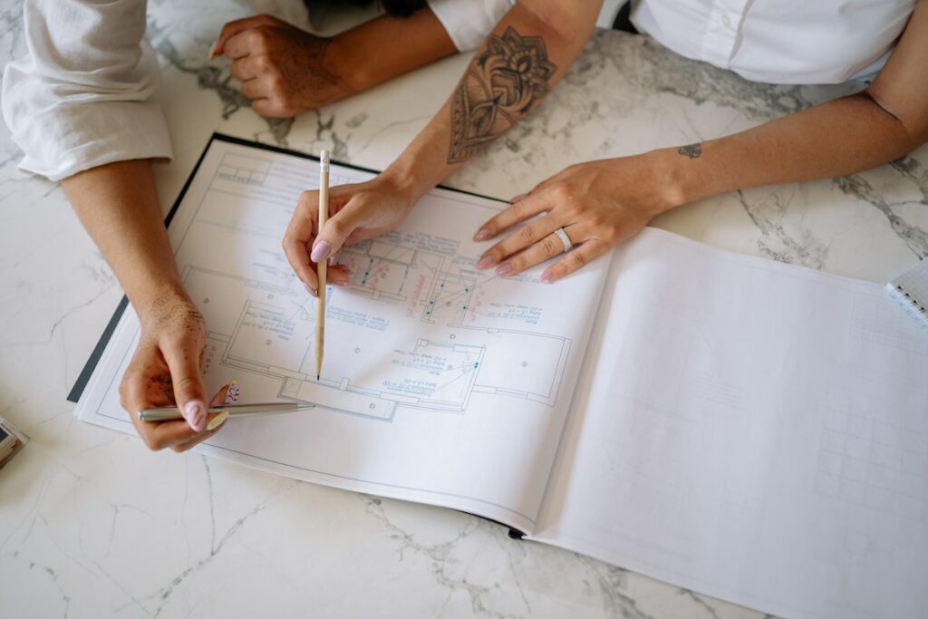 People-looking-at-the-floor-plan-on-the-marble-top-table